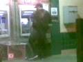 Mexican getting money from the ATM while dancing to Lady Gaga