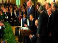 Obama signs historic $938 billion health overhaul