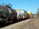 Q685 heads South past the SAL depot in Wadley, AL on the main as Q592 takes the siding.