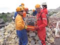 Students learning how to do a stretcher pass on small rubble pile.