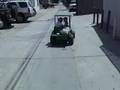 J.R. drives his truck down the alley