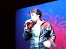 chris macdonald performing viva las vegas in black leather during the 60's portion of his tribute, memories of elvis in concert with his orchestra, back up singers and dancers.