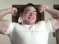 Young muscle guy flexing huge arms