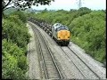 37905 grinds up the bank with a heavy load of steel slabs