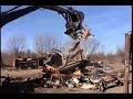 this is a school bus that is being ripped appart, with a backhoe, this is our job.ain't it great!!!