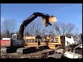 this is a school bus that is being ripped appart, with a backhoe, this is our job.ain't it great!!!