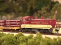dallas model works flat car loader in action loading an ho scale flat car.