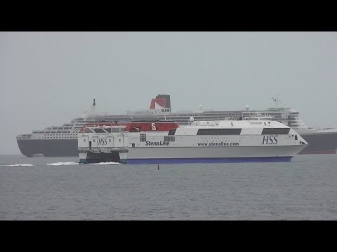 Laoghaire - The Stena H.S.S. Explorer passes the RMS Queen Mary 2 cruise liner as it departs Dun Laoghaire harbour on the 16th of May 2013. The QM2 is the largest ocean ...
