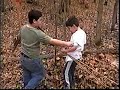 Boys in primitive shelter coming out for a little atlatl action