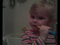 Alinza brushing her teeth