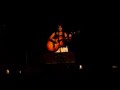 tish singing something in the rain at a concert in august.