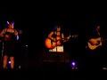 tish singing something in the rain at a concert in august.