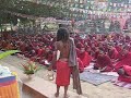 Wacky hindu sadhu dancing in front of hundreds of Tibetan buddhist monks chanting beside the bodhi tree in Bodhgaya.  He ignores the guard trying to get him to leave.  The monks seem to be mostly taking it with good humor. - Sadhu amuses Tibetan monks in Bodhgaya