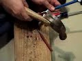 Tapping out the old rivets from the trunnions
