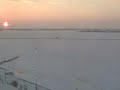 this video was taken of the frozen dvina river in  arkhangelsk, russia.  the people are walking across the frozen river to get to their homes on the other side.  several times a day, ice breakers would come through and break open a path for ships.  within minutes, the pedestrian commuters crossed again.  we walked to the point of the ice breakers one evening, but did not cross to the other side.  that night, we saw the northern lights.