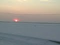 this video was taken of the frozen dvina river in  arkhangelsk, russia.  the people are walking across the frozen river to get to their homes on the other side.  several times a day, ice breakers would come through and break open a path for ships.  within minutes, the pedestrian commuters crossed again.  we walked to the point of the ice breakers one evening, but did not cross to the other side.  that night, we saw the northern lights.