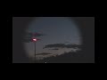 UFO crafts throw lights below/ another hovers over town
