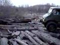 Unimog crawling over logs