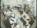 Guy attacks his co-worker across the desk at the office.