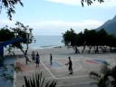 By the sea, on isolated roadside small town of La Ciénaga (pop. 7,715) in Barahona, SouthWest region of the Dominican Republic. No fancy sneakers or uniform required to play here. Actually, most play