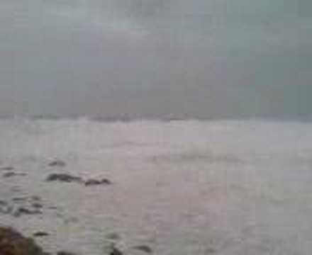 Big waves hitting breakwater at Sennen Cove