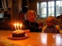 Zoe blows out the candles on her cake on her 3rd Birthday