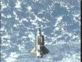 Space Shuttle Discovery Flies Around the International Space Station
