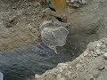 Excavator Ripping Rock