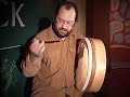 hello! my name is yura sergeev, i play the bodhran (you can say it the different way - boyran or bodhran - as you like). the correct i think bodrhan. this word means thunderous or muffled. i've been playing it for several years. and i began to play bodrhan when i met the best bodhran player frank mcguaer by a lucky chance. we had a lot of talk, he was teaching me. i also had met there local craftmen who tought me to make that kind of that kind drum. the fundamental move in playng the bodhran reminds the same when playing the guitar or balalaika with plectra. one end of the stick moves up and down. to make it more beautiful may be add triols, one should also use the other end of stick. bodgranist use his left hand widely. left hand is responsible for tune and timbre of the drum and it enables you to produce open or muffled sound. so it 'open' or 'muffle' membrane and change its tune.
with the help of left hand you can imitate the melody that is played by soloist. also you can play on the rim. you can also use the fully opened membrane and in this case it sounds like shaman drum. or you can combine all this types of playing. there is rather tricky movement - left hand beats. the instrument you see is modern. it doesn't has the cross. now it is rarely used and you can see only in souvenir variants. also it has tuning ring and pegs which enable you to adjust the tune if the membrane. classical bodhran is made of birch and goat skin. but this one is made of goat skin and maple and pear tree. skin must only from goat and wood may be different. all the more maple is very good for musical instruments. stick is called bodhran-stick. but also with other different things, including hands :). usually stick is made of heavy wood which sink in water. there are a lot of different forms of sticks. there is no single common school of playing. techniques are still developing. you can play with your hands, sticks, which you can hold at middle or at the one end of it, in this case the strike becomes more powerful but it is not apropriate for playing sophisticated things (triols), with brushes ( soft or hard). and i have personal invention - soft stick. at least i haven't seen it before. sound becames more soft and reminds shaman drum.