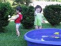 morgan & nate playin in the pool & ridin their car 07-14-06