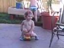 Avery trying to ride a toy truck