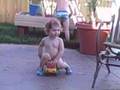 Avery trying to ride a toy truck
