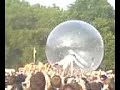 Wayne Coyne from flaming lips crowd surfing in a giant bubbl