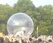 Wayne Coyne from flaming lips crowd surfing in a giant bubbl