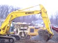 excavator loading rock crusher loader cleans up the mess