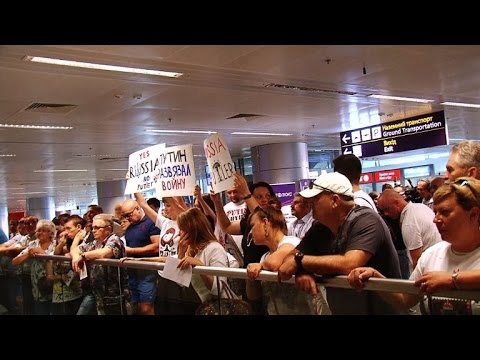 airport - Ukrainian activists hold a flash mob at Boryspil international airport in Kiev on Saturday to welcome Russian visitors with anti-Putin leaflets and signs, calling them to watch news from different...