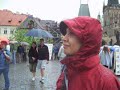 madhavi and jeremy continue to cross the charles bridge in prague in the rain