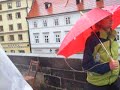 madhavi and jeremy continue to cross the charles bridge in prague in the rain