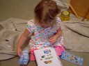 Eliana puts stickers in her sticker book Eliana puts stickers in her sticker book