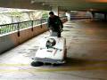 Elgee Mfg walk behind sweeper cleans parking garage.mov