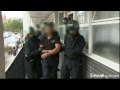 Riot police raid suspected looters in London