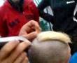 Adam Edwards having hair shaved at bbq.