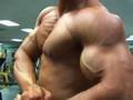 Bren Baldwin posing biceps and pecs
