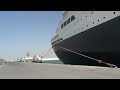 QE2 in Port Rashid DUBAI. The lighting is on at night and there is signes of smoke from the funnel. The port is secure from the road with security checking ID and boarding passes to cruise ships. If your lucky to be there on a cruise you can walk around the port road to see it or cut through where the taxi driver hang out in a building. The area is not fenced off so you can walk up to the QE2. At the gang way a sign says UNAUTHORIZED VISITORS ARE NOT ALLOWED ON THE QUEEN ELIZABETH 2 AT ANY TIME as I advanced filmimg the security guard shouted something from inside so I politly walked passed. The QE2 has now been there since NOV 2008. any more info and I will ad it. Happy viewing and be the first onboard filming without getting into trouble......