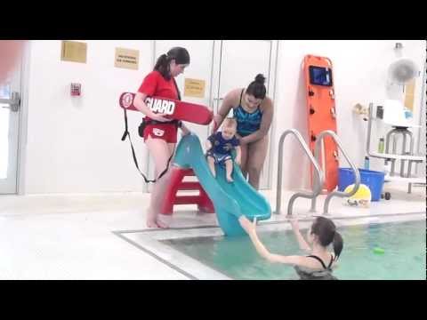 Class 224 - James Roy's first swim class at Woburn YMCA. He goes down a slide into the water! He loved kicking around in the pool.