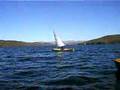 A cedar-strip canoe sails by and tacks