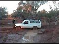 Two 4WD stuck in the mud while crossing a stream.