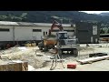 Construction works. Mini Excavator loads a Paus mini dumper.