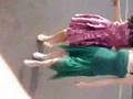 Two Cute Girls Wearing Dresses Singing And Dancing For Their Friends