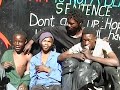 during a theatre production in south africa, geert mul had handed out ten digital video cameras to street-kids of hillbrow, johannesburg. he asked them to portray their friends and their surroundings. out of the 14 hours of dramatic video material that returned, mul selected a few seconds to create the video portraits 'look at us' and dreamboy
 
'look at us' is an invitation to look straight into the eyes of street kids at downtown johannesburg.  
but it also challenges us to 'look at ourselves' trough the eyes of those same kids, who appear to be staring at us in return.
 

